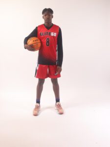 A boy in a red basketball jersey, 8