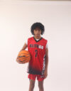 A boy in a red basketball jersey, 7