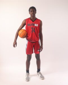 A boy in a red basketball jersey, 74