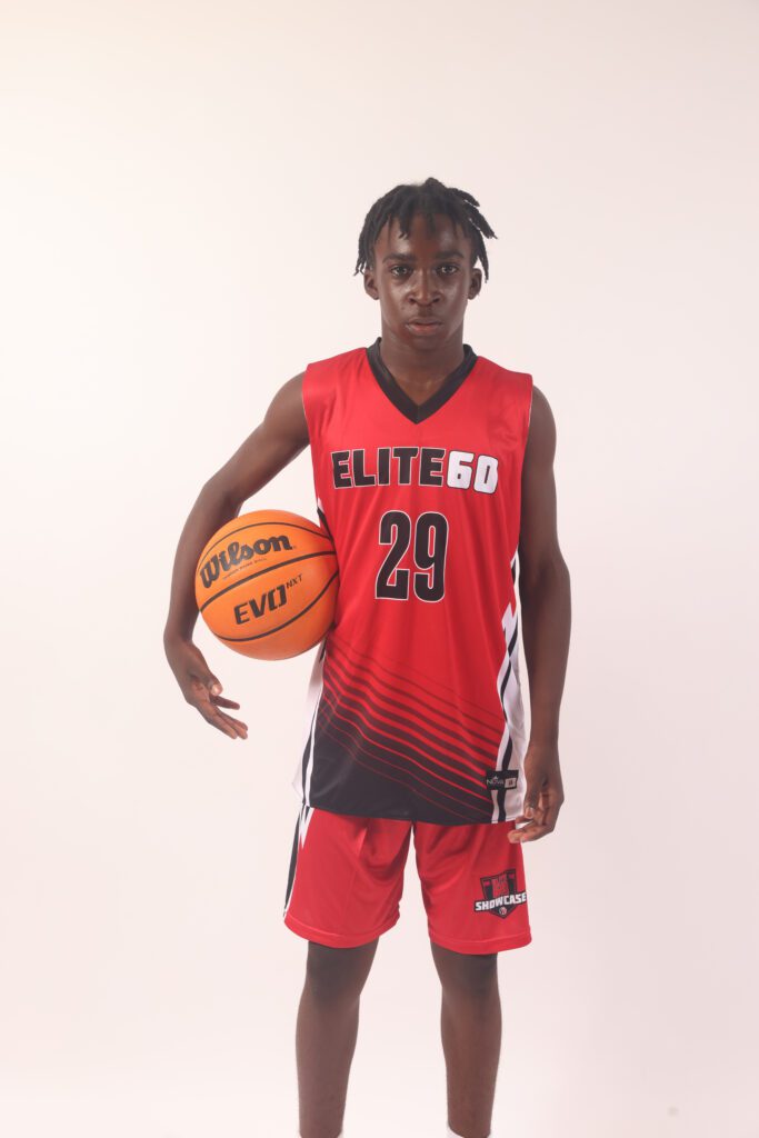 A boy in a red basketball jersey, 29