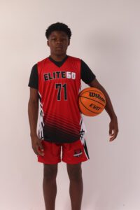 A boy in a red basketball jersey, 71