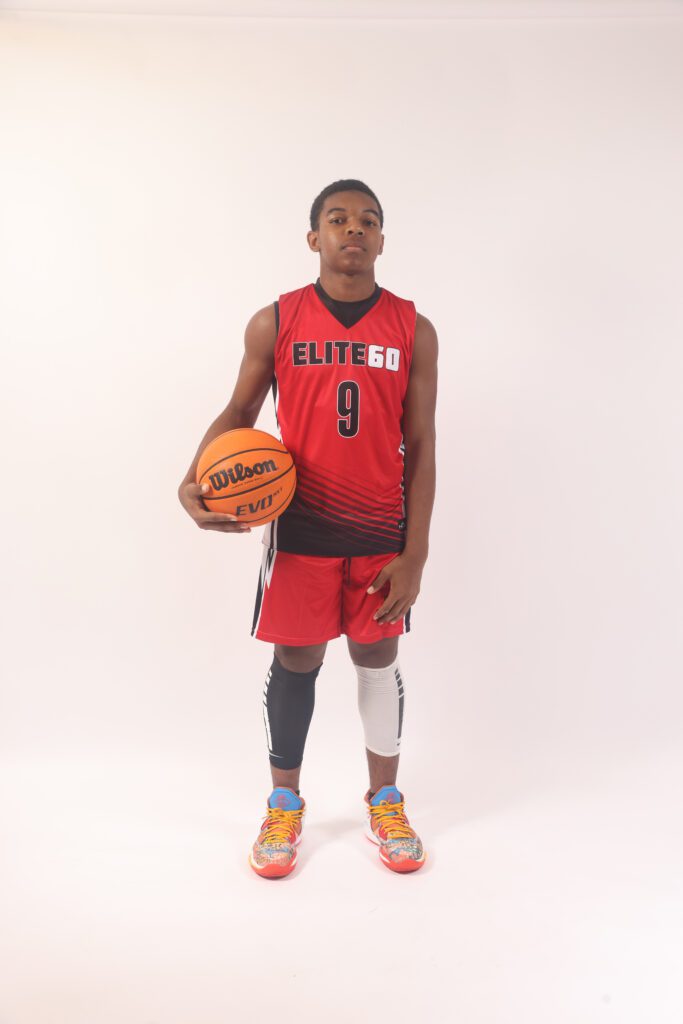 A boy in a red basketball jersey, 5