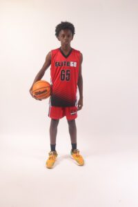 A boy in a red basketball jersey, 65