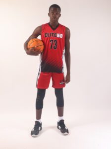 A boy in a red basketball jersey, 23