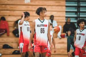 A boy playing basketball wearing the Elite60 jersey number 65