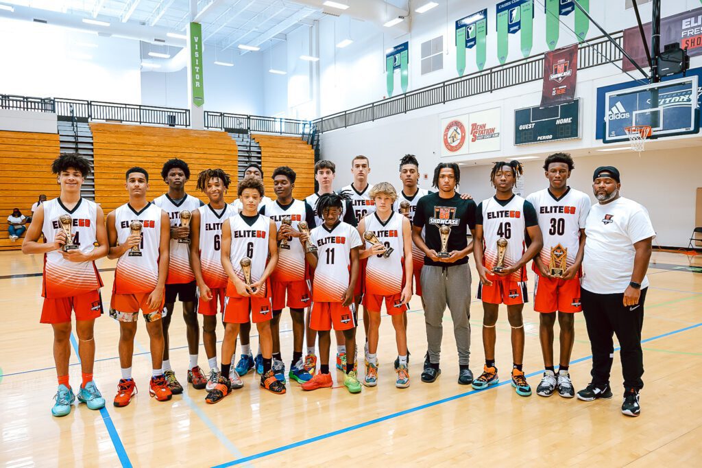 Boys wearing the white jersey holding trophies