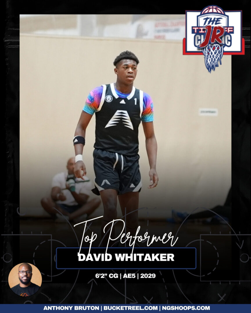 David Whitaker playing basketball in a black uniform on court.