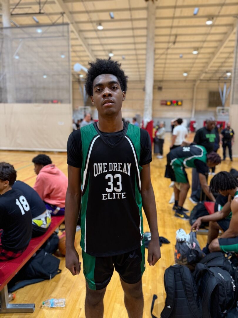 Young basketball player in a gym wearing a black "One Dream Elite" jersey with number 33.