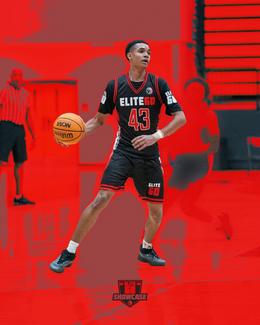 Basketball player in black uniform dribbling on court.