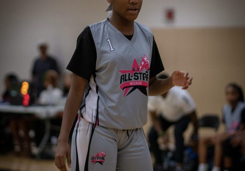 A girl in all stars gray jersey outside black t shirt