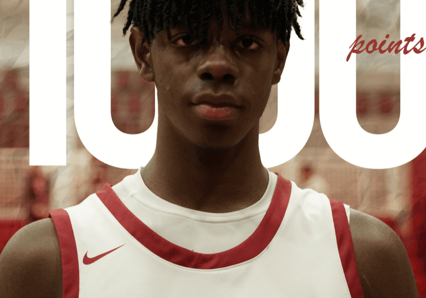 Young basketball player in a HIES jersey celebrating 1000 points.