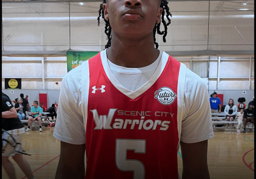 Young basketball player in red Warriors jersey number 5.
