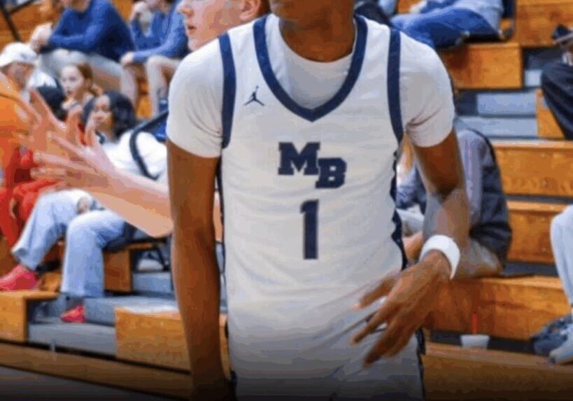 Cadien Hudson dribbling a basketball in a gymnasium.