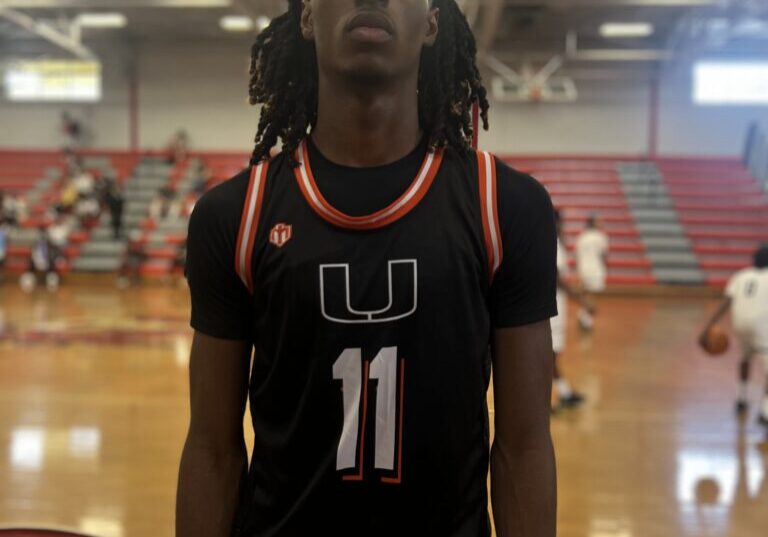 Basketball player wearing jersey number 11 on the court.