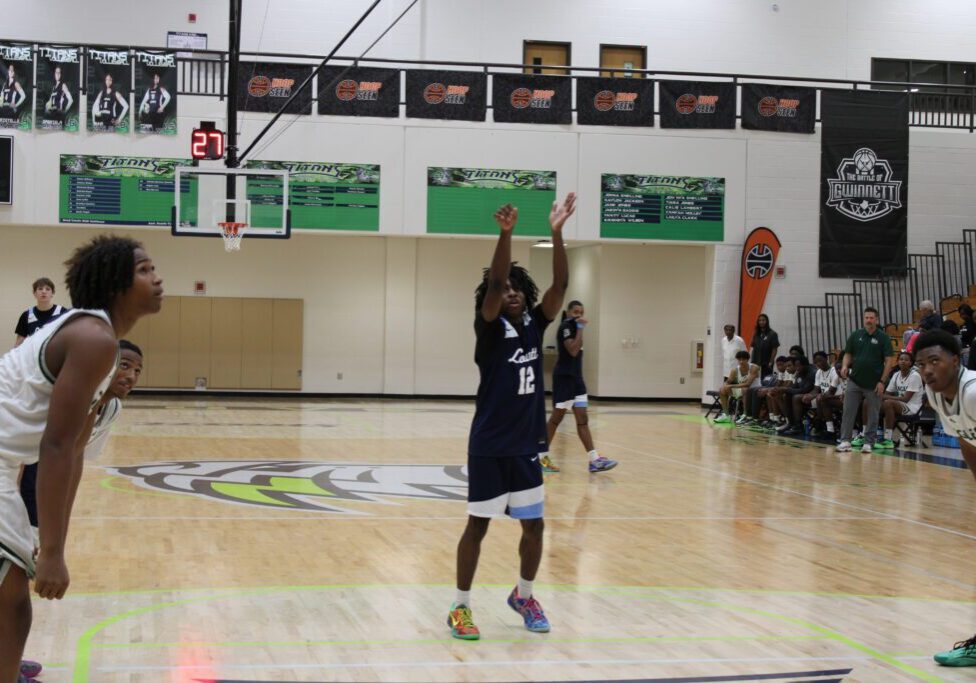 Young basketball player shooting a free throw in a gym.