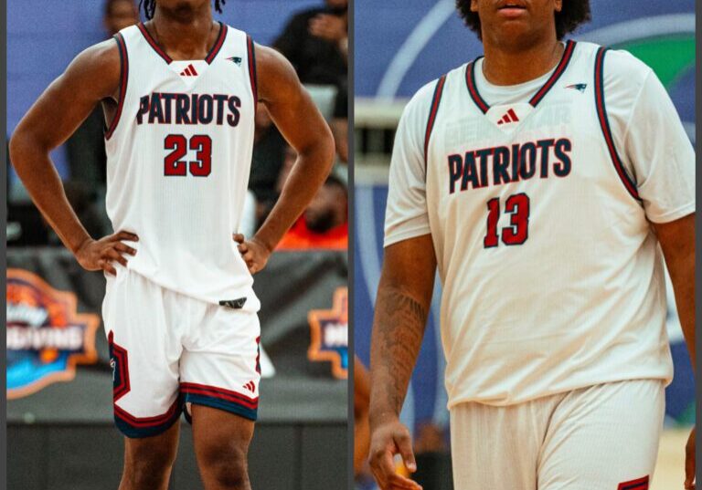 Two basketball players in Patriots uniforms on the court.