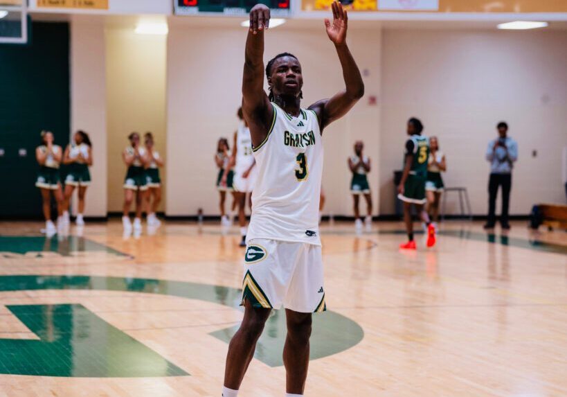 Basketball player in white jersey celebrating on the court.